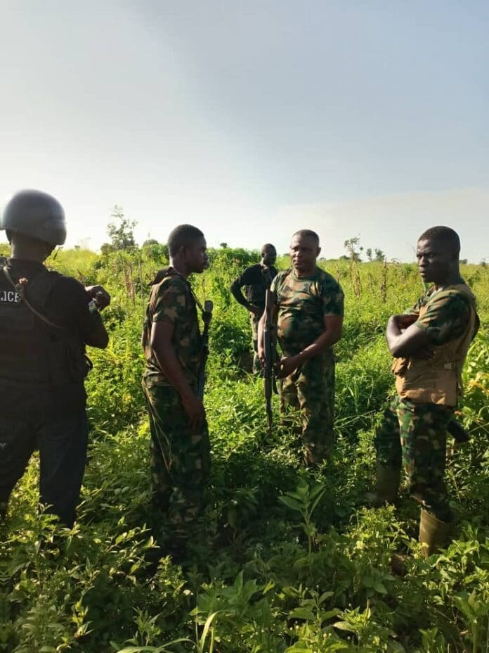 Soldiers and volunteer guards search for bodies of murdered residents of Benue State north of Makurdi in early 2023.
