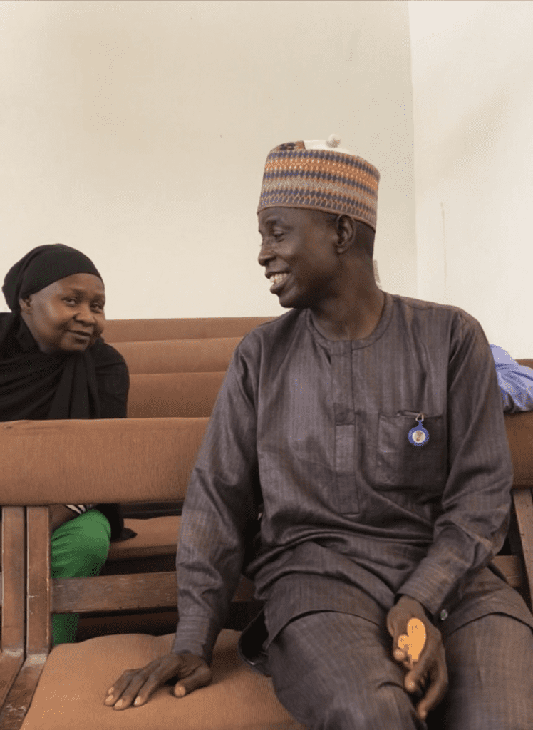 Rhoda Jatau Adamu, left sits in court behind her husband, Ya’u Adamu on Oct.16. credit: Masara Kim. 