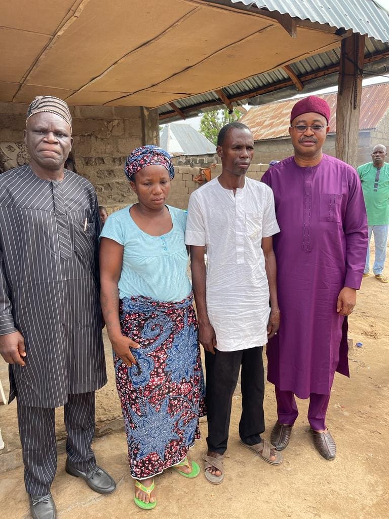 Faces of devastation: at left and far right are Evangelical Church Winning All clergy consoling the mother and father of Deborah two weeks after her burial. Mr Emmanuel Garba was asked if he would sue the authorities. "No," he replied. "We leave everything to God."