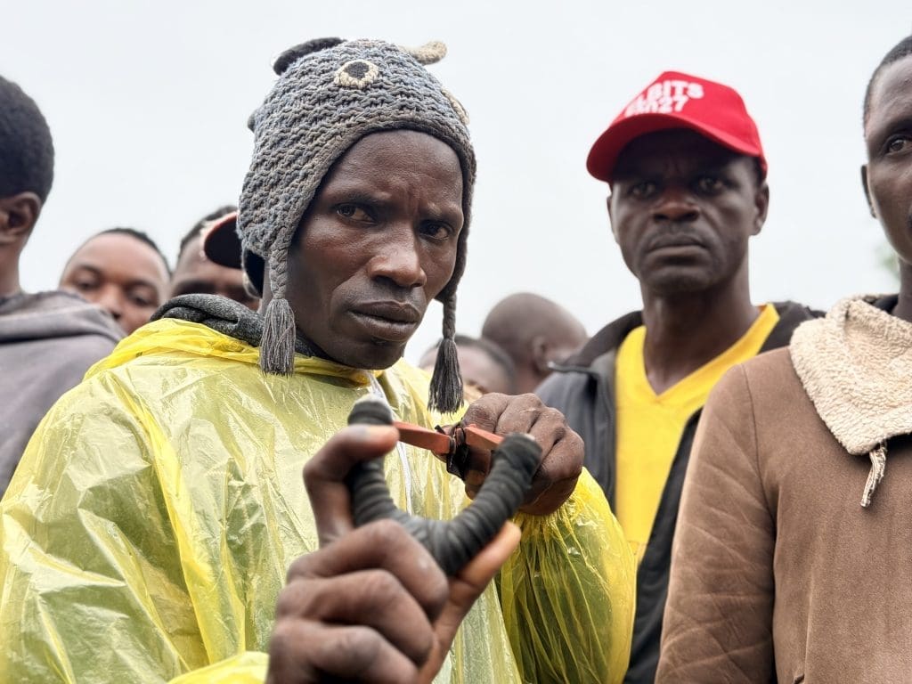 Sunday Ezekiel, youth leader of Gwom Ajang village aims with a slingshot after facing off against terrorists with assault rifles on May 31. 
Credit Masara Kim 