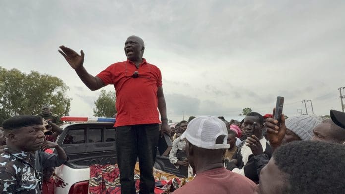 Pastor Ezekiel Dachomo calls for self-defense on July 5 while standing in the back of a truck carrying the bodies of slain civilian guards. Photo by by Masara Kim/TruthNigeria.