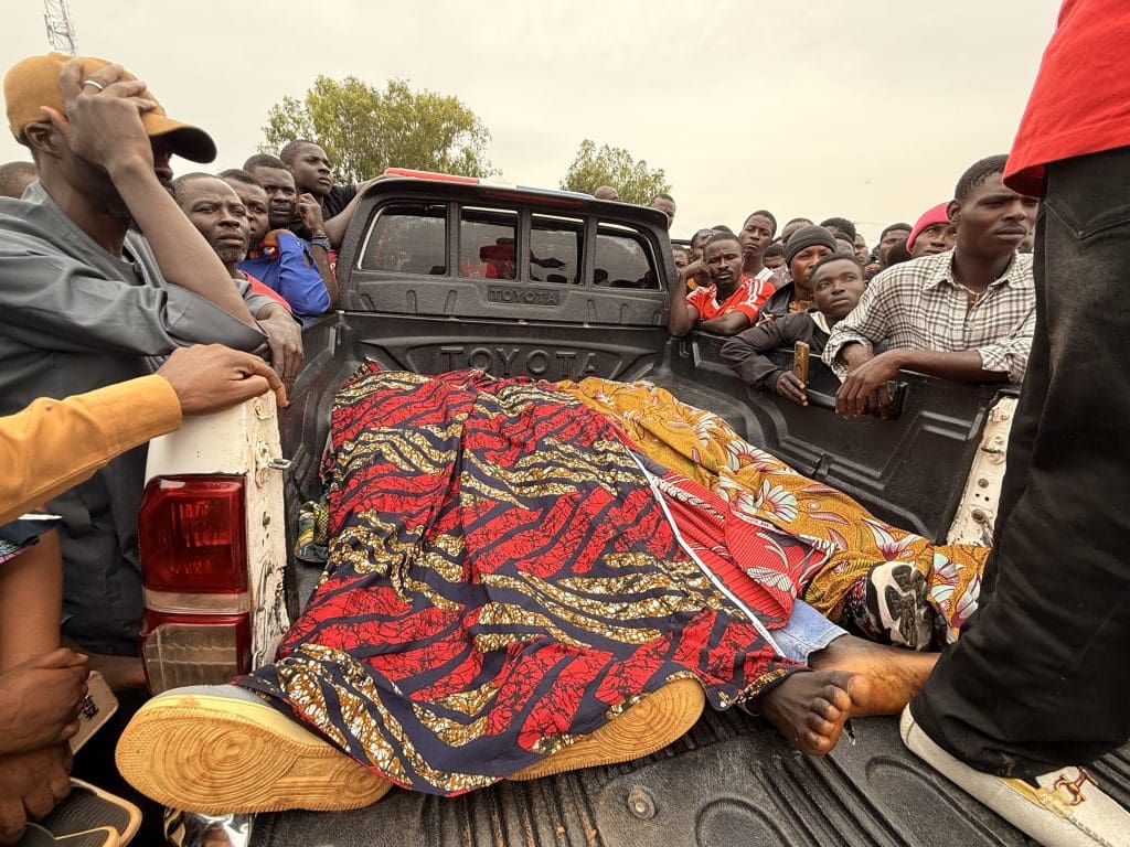 The bodies of three civilian guards killed near Jos on July 4 lie in the back of a truck before a mass burial. Photo by by Masara Kim/TruthNigeria.